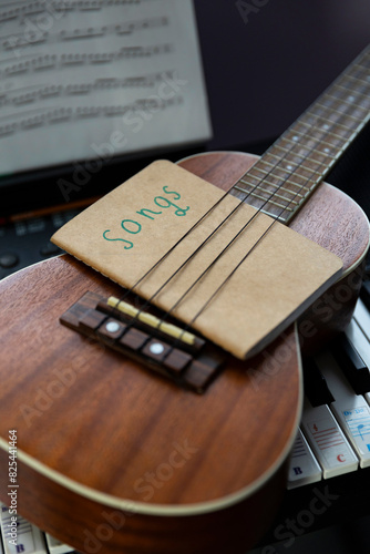 Ukulele with music Song Book selective focus keyboard  photo