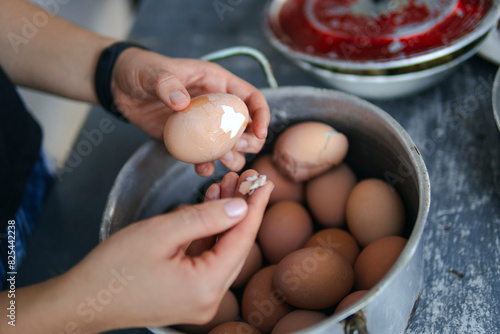 Woman peeling eggs photo