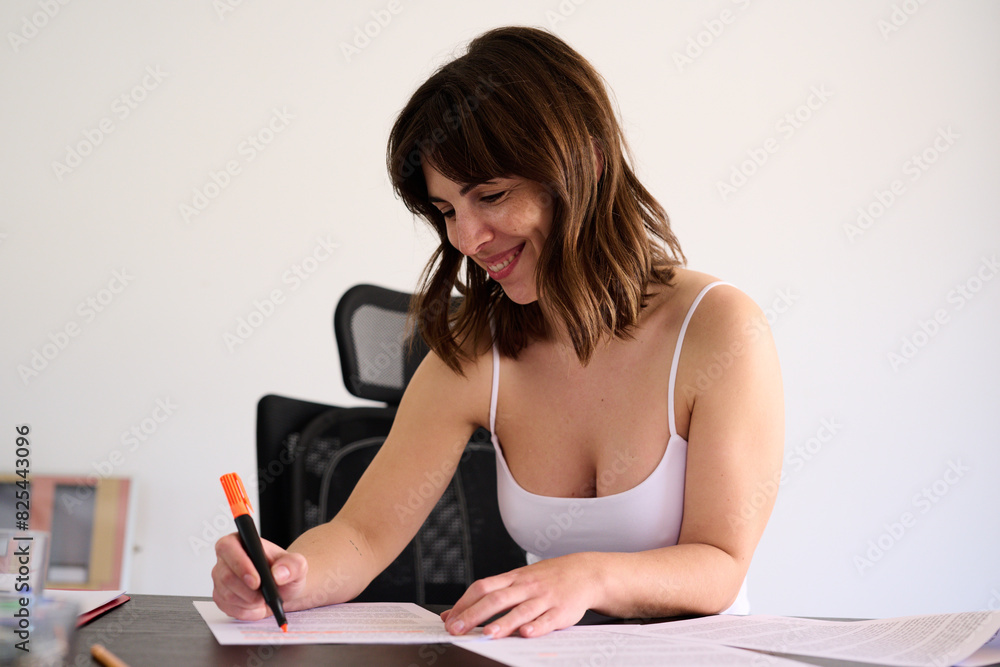 Happy Woman highlighting on Documents Happy Woman highlighting on Documents