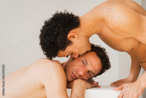 Loving Gay Couple Rest Heads On Each Other Tenderly photo