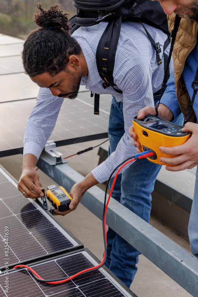 Male engineers using equipment on solar panel Male engineers using equipment on solar panel