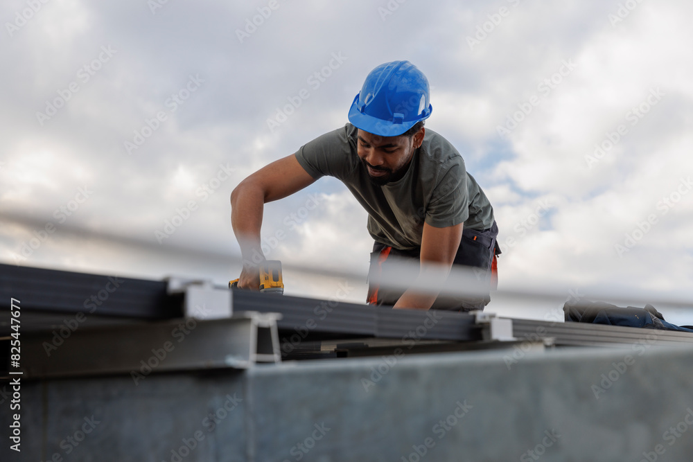 Technician installing solar panels on rooftop Technician installing solar panels on rooftop