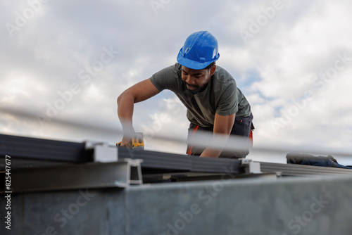 Technician installing solar panels on rooftop