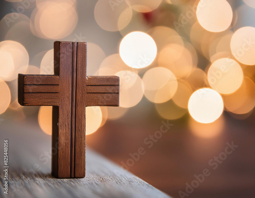cross on wooden table with bokeh lights, christmas and new year concept. photo