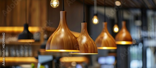 A restaurant with a variety of wooden light fixtures hanging from the ceiling