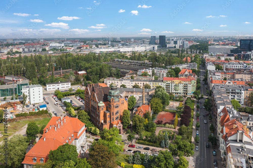 Summer skyline cityscape of district Wilda in Poznan, Poland. Wide panoramic aerial view. Poznań University of Technology building (Politechnika Poznańska) in the foreground.