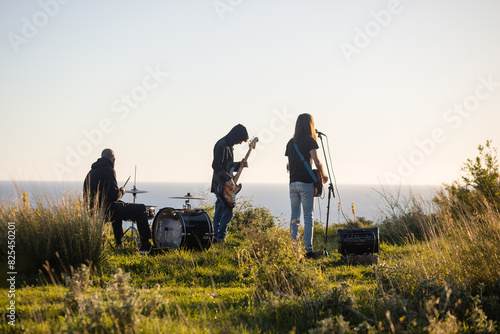 Music band rehearsing outdoors photo
