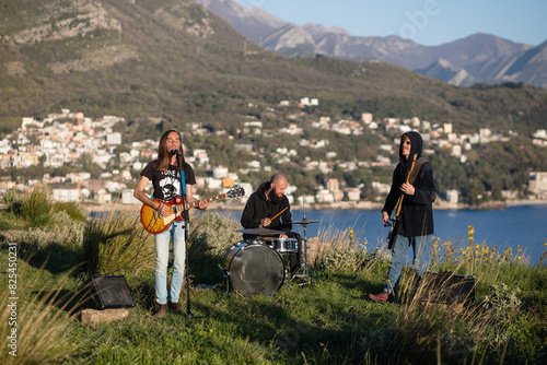 Trip hop trio performing in nature photo