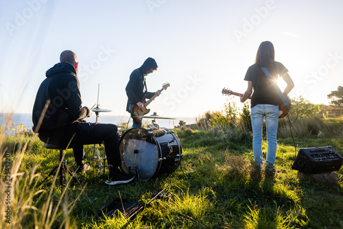 Rock band rehearsing outdoors photo