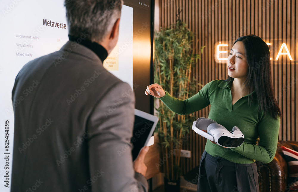 Businesswoman presenting virtual reality headset concept Businesswoman presenting virtual reality headset concept