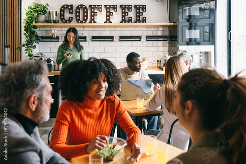 Diverse group of friends enjoying time at a coffee shop photo