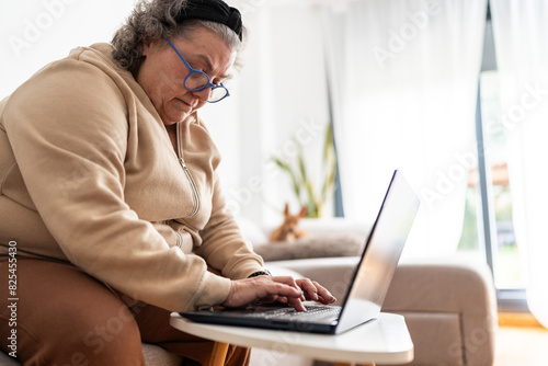 Woman with eyeglasses using a laptop. photo