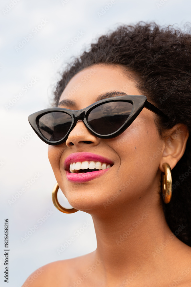 Woman Smiling in Chic Sunglasses Woman Smiling in Chic Sunglasses