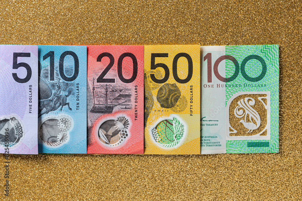 © Shava Cueva/Stocksy - Australian money of different denominations arranged in a row