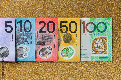 Australian money of different denominations arranged in a row photo
