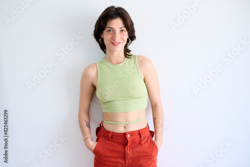 Smiling Woman in Green Top and Orange Pants