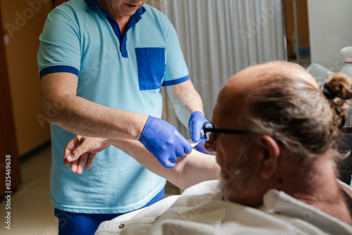 nurse applying an adhesive bandage on a patient photo