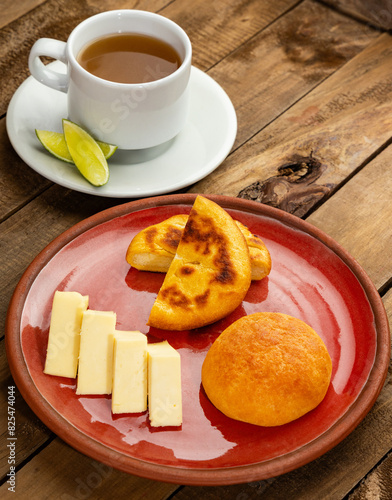 Boyacense arepa for breakfast, accompanied with cheese, almojabana and aguapanela with lemon photo