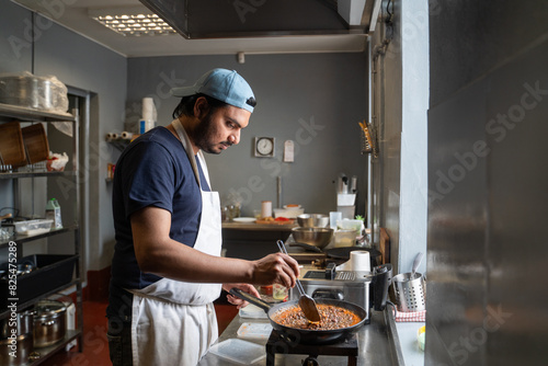 Busy Worker At Indian Restaurant Kitchen photo