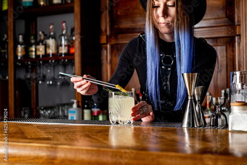 Bartender prepares cocktail at the bar counter photo