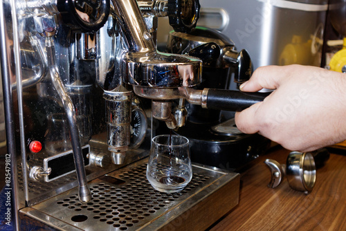 barista preparing coffee in coffee maker photo