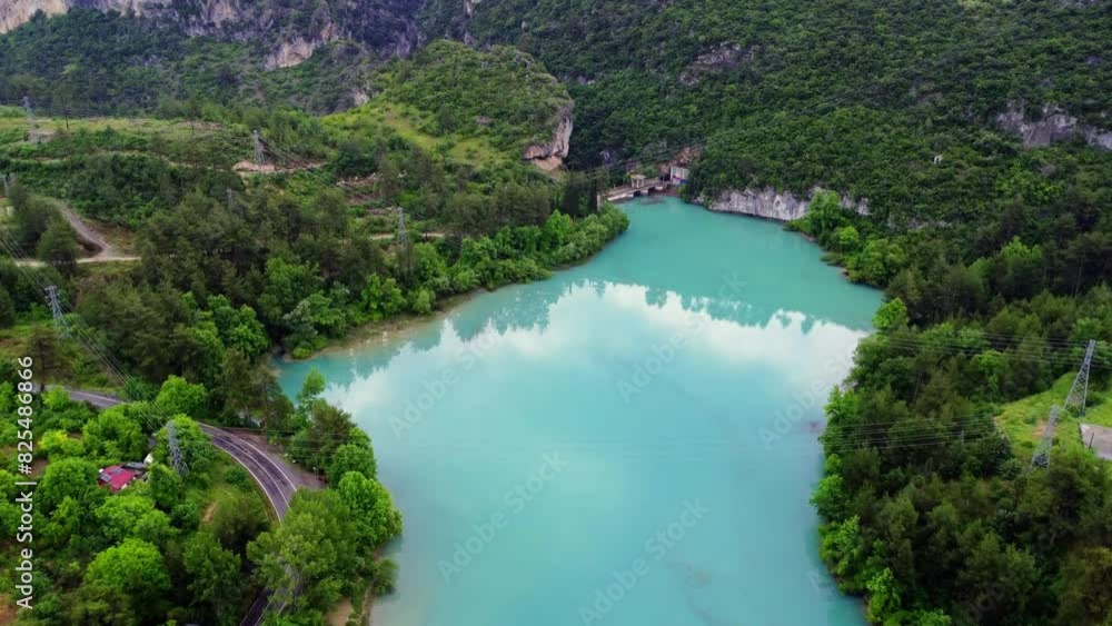 Discover a breathtaking turquoise mountain lake nestled amidst verdant trees, offering a tranquil and picturesque escape Discover a breathtaking turquoise mountain lake nestled amidst verdant trees, offering a tranquil and picturesque escape
