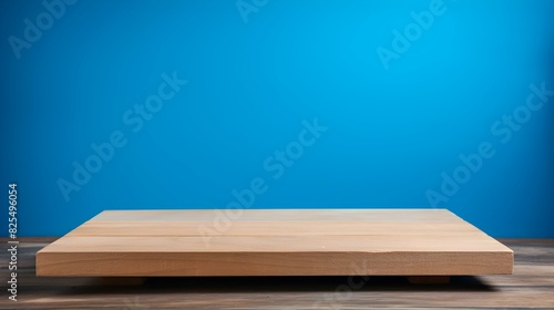 Close up of a square wooden Pedestal for Product Presentation. Empty blue Showroom © drdigitaldesign