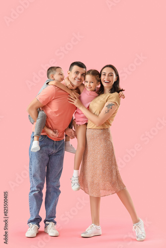 Happy family on pink backgr...