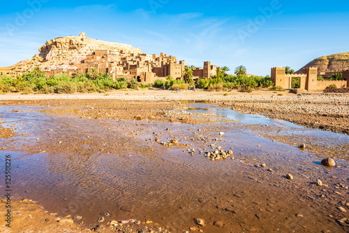 View of river and Ksar Ait Ben Haddou, old Berber adobe-brick village or kasbah in green oasis with palm trees, Ouarzazate, Morocco, North Africa