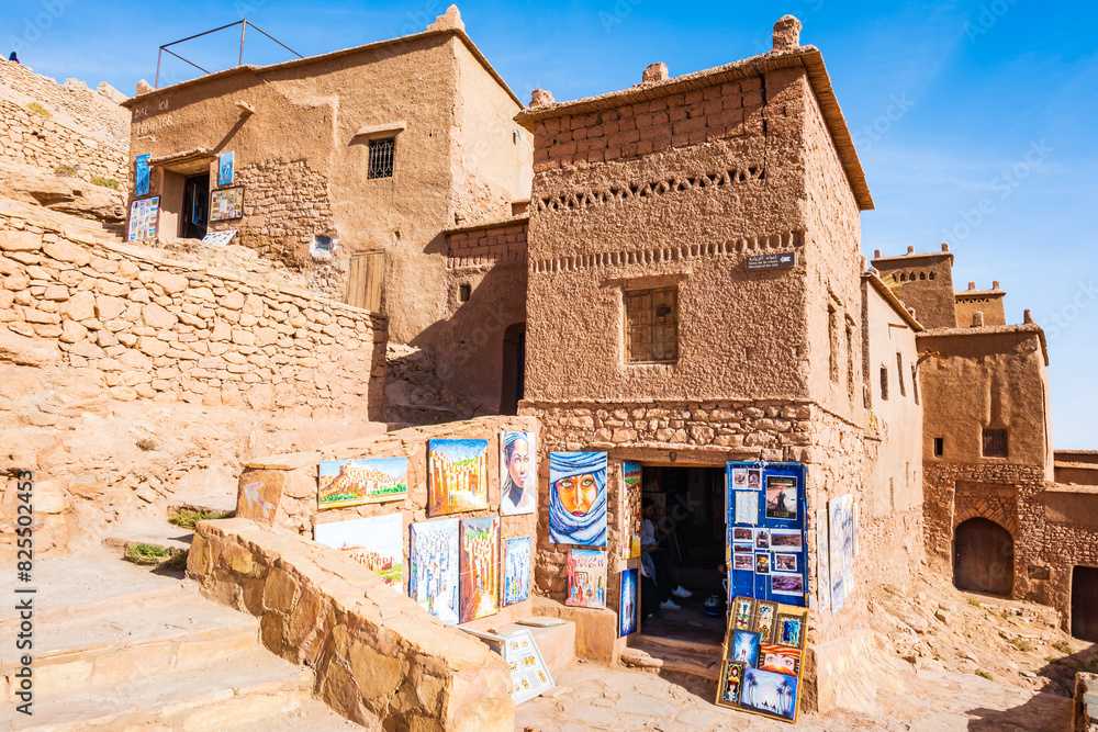 Traditional Moroccan souvenirs for sale in narrow street of Ksar Ait Ben Haddou, old Berber ancient village or kasbah, Morocco, North Africa.