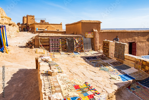 AIT BEN HADDOU, MOROCCO - NOV 9, 2023: Traditional Moroccan souvenirs for sale in narrow street of Ksar Ait Ben Haddou, old Berber ancient village or kasbah, Morocco, North Africa. photo