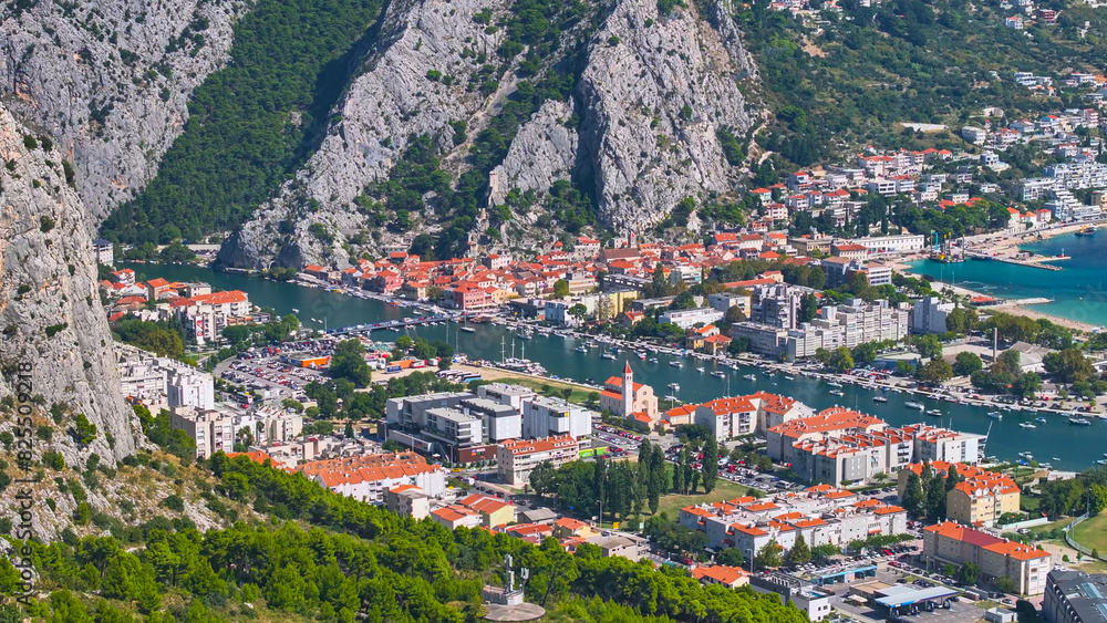 AERIAL: Scenic drone view of the residential area of Omis next to Cetina river.