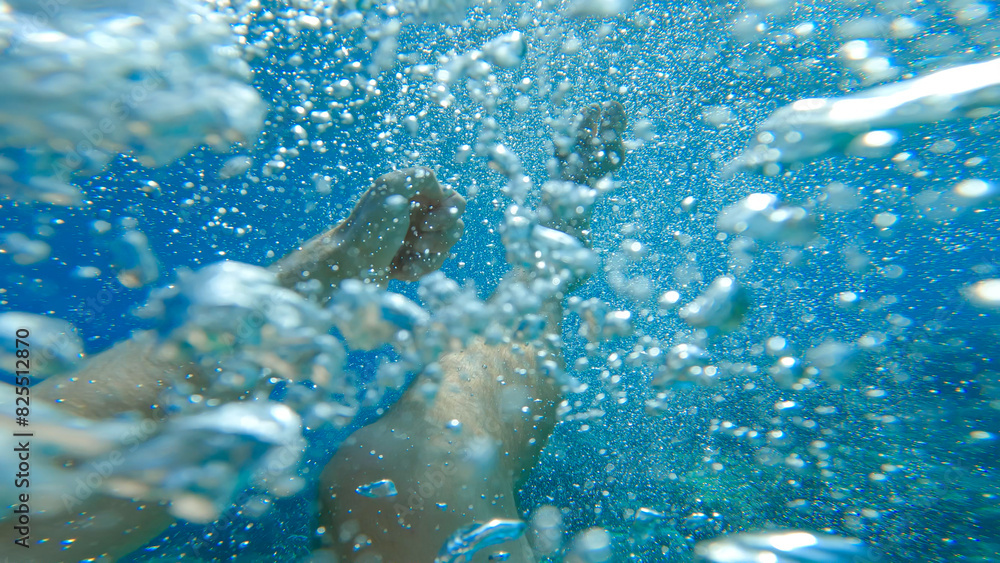 POV UNDERWATER: Male swimmer desperately tries to swim back above sea surface to get some air before drowning. Unrecognizable man frantically flailing his arms and legs to float out of the water. POV UNDERWATER: Male swimmer desperately tries to swim back above sea surface to get some air before drowning. Unrecognizable man frantically flailing his arms and legs to float out of the water.