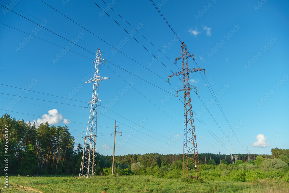 Power lines running through the forest. The support of an overhead power line. Natural landscape and technological progress. Power lines running through the forest. The support of an overhead power line. Natural landscape and technological progress.