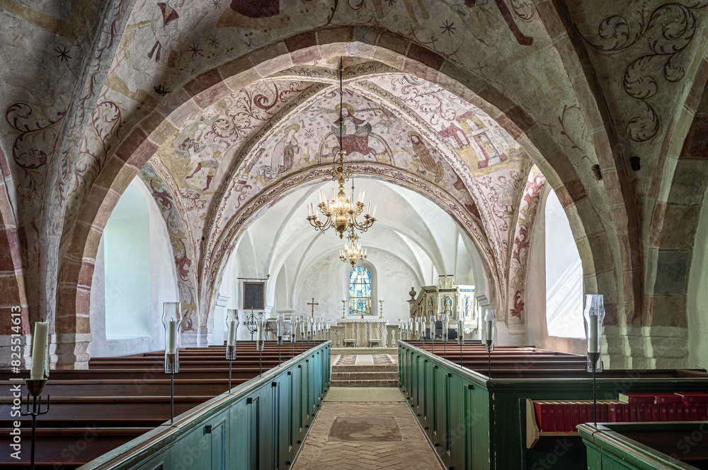 interior of an old church with medieval paintings in the vaults
