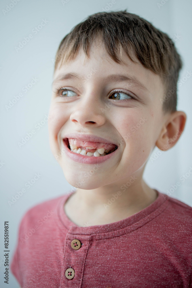 Kid losing a baby tooth and a new permanent tooth coming out Kid losing a baby tooth and a new permanent tooth coming out