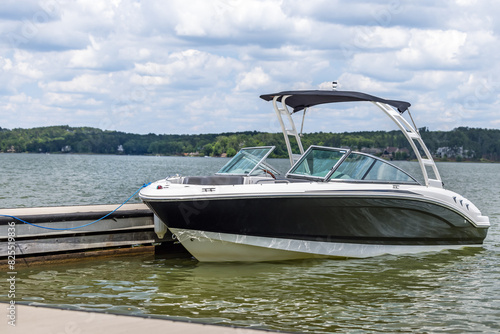 Powerboat at private boat dock on freshwater lake.