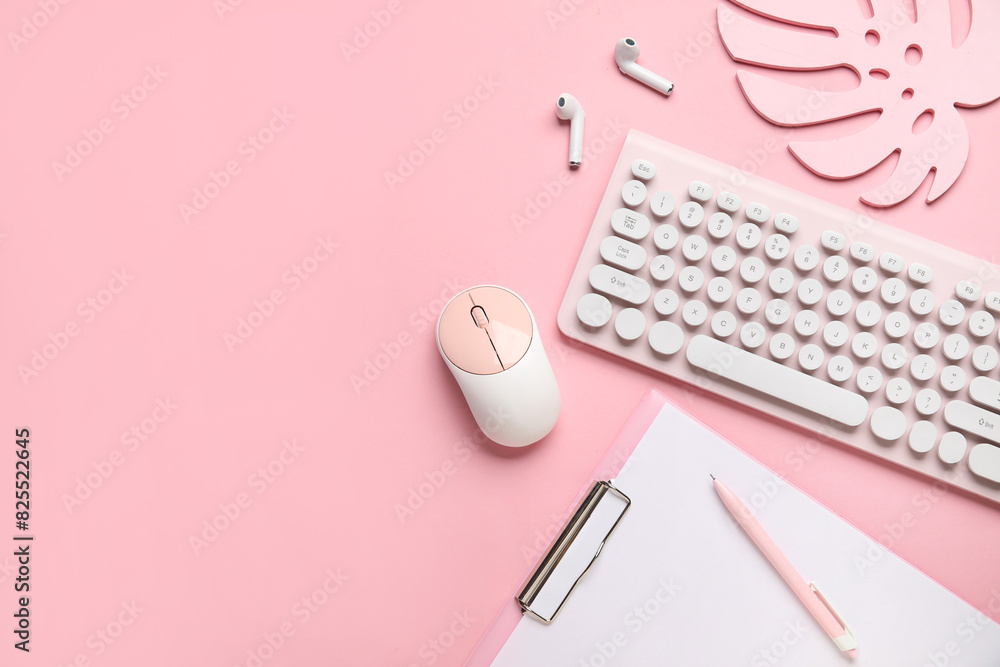 PC keyboard, mouse, earphones and stationery on pink background PC keyboard, mouse, earphones and stationery on pink background