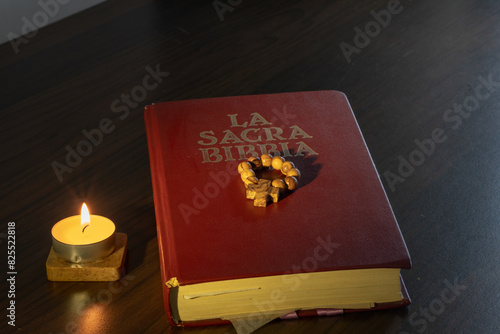 the prayer with the Bible and the rosary are a source of inspiration and meditation aided by the light of the word represented by the lit candle.