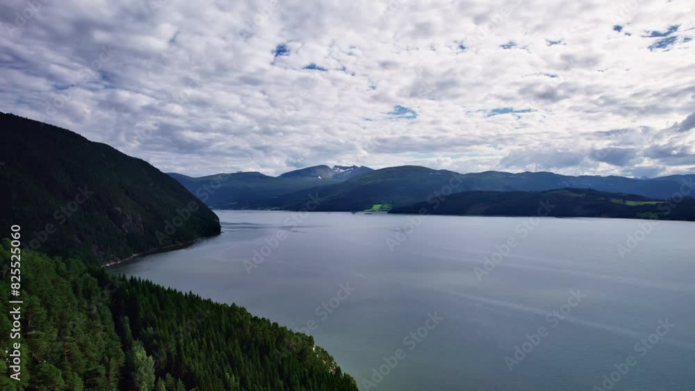 A peaceful aerial shot of the Tingvollfjorden in Norway, showcasing the stunning natural beauty of the fjord and surrounding mountains. A peaceful aerial shot of the Tingvollfjorden in Norway, showcasing the stunning natural beauty of the fjord and surrounding mountains.