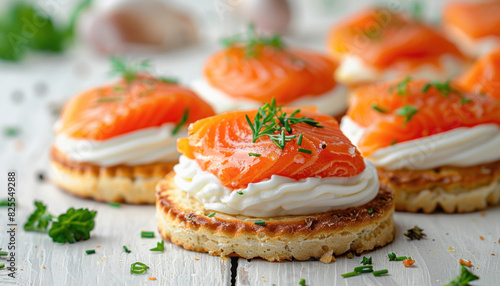A close up image of a plate of food featuring salmon and whipped cream, displayed on a table