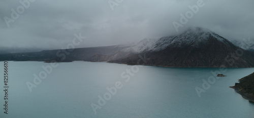 Snowy mountains over Lake Potrerillos in Mendoza, Argentina, on a cold winter day. Aerial view.