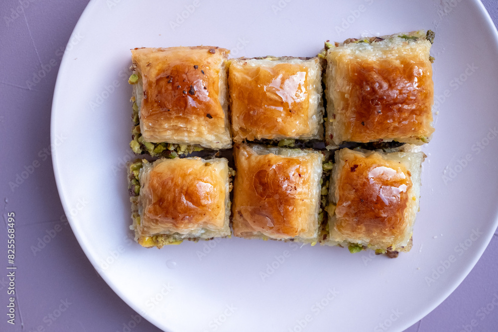 Local Turkish baklava on a white plate in a 360 degree rotating display case Local Turkish baklava on a white plate in a 360 degree rotating display case