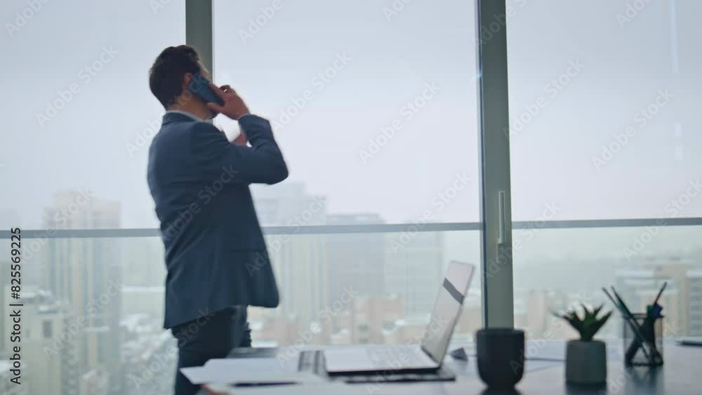 Mad manager screaming cellphone gesturing hands yelling at workplace back view Mad manager screaming cellphone gesturing hands yelling at workplace back view