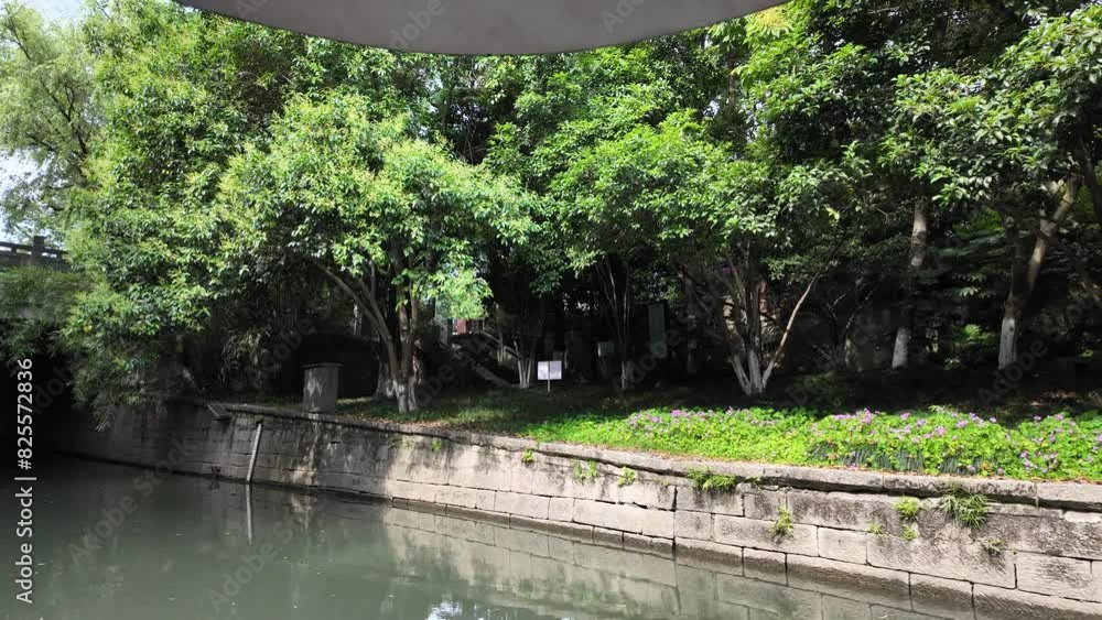 Embark on a tranquil boat trip in Hangzhou, China, gliding along a serene river surrounded by ancient buildings and bridges. Embark on a tranquil boat trip in Hangzhou, China, gliding along a serene river surrounded by ancient buildings and bridges.
