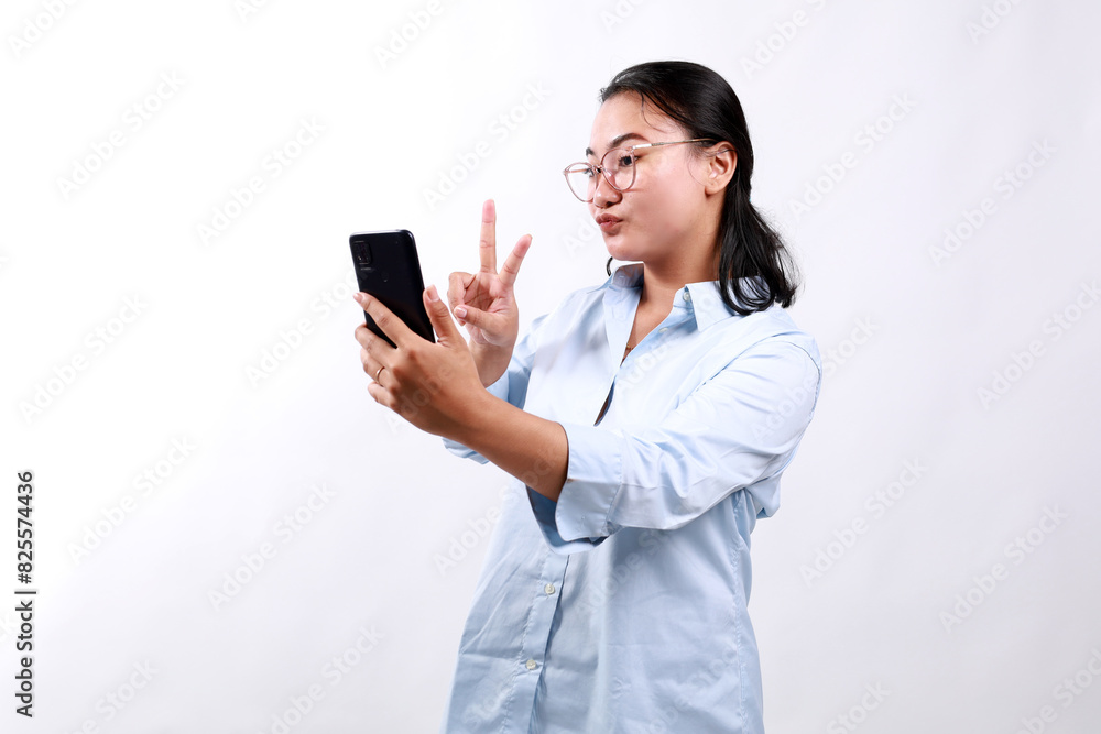 Portrait of asian woman in formal dress using mobile phone for interaction video calling by showing two fingers. Isolated on white background Portrait of asian woman in formal dress using mobile phone for interaction video calling by showing two fingers. Isolated on white background