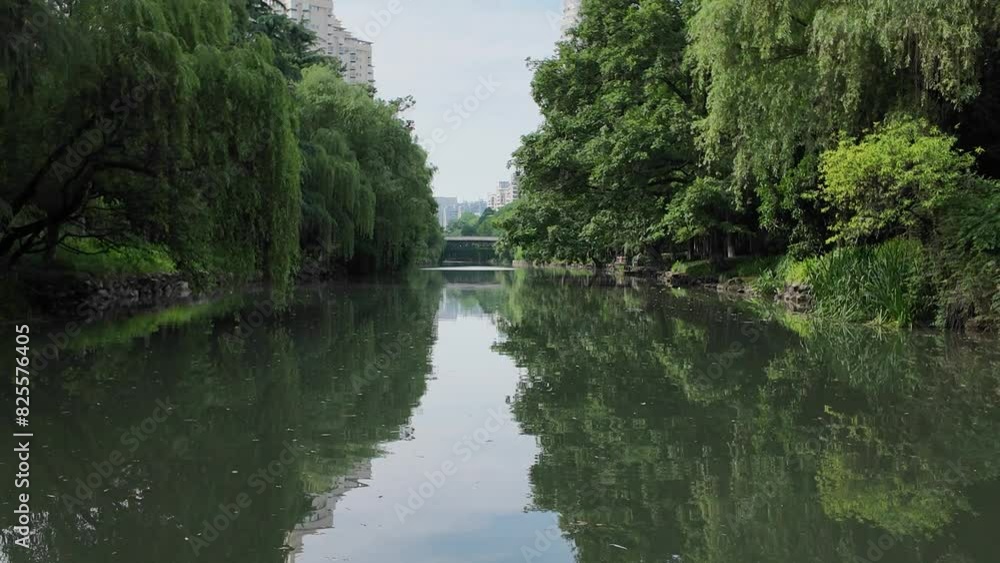 Embark on a tranquil boat trip in Hangzhou, China, gliding along a serene river surrounded by ancient buildings and bridges. Embark on a tranquil boat trip in Hangzhou, China, gliding along a serene river surrounded by ancient buildings and bridges.