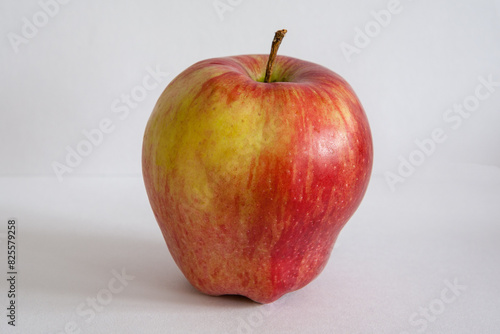 Close-up one red apple on a gray background for publication, poster, calendar, post, screensaver, wallpaper, cover. High quality photo © vveronka