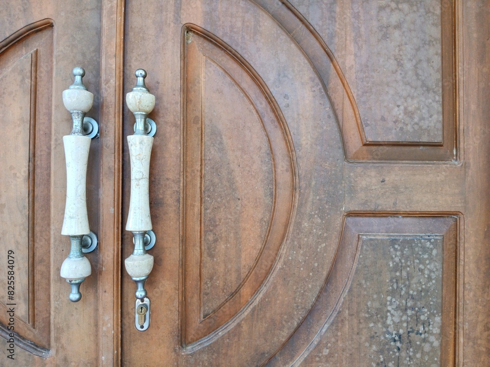 Fototapeta premium Classic style house door with natural wood texture with marble handle, for decoration, architecture, building design, property, etc.