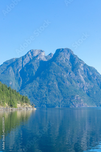 Peaceful waters and large mountain peak in the distance